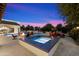 Backyard paradise featuring a hot tub and a stone fireplace at 8515 E Sutton Dr, Scottsdale, AZ 85260