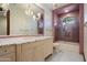 Elegant bathroom with a marble countertop vanity and a glass-enclosed shower with pink tile accents at 8515 E Sutton Dr, Scottsdale, AZ 85260