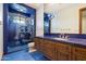 Unique bathroom featuring blue tiled floor and shower with star accents and wood vanity with sink at 8515 E Sutton Dr, Scottsdale, AZ 85260