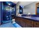 Unique bathroom with blue mosaic tile, a star-themed shower, and wood vanity at 8515 E Sutton Dr, Scottsdale, AZ 85260