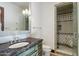 Bright bathroom features a walk-in shower, vanity, and decorative tile work at 8515 E Sutton Dr, Scottsdale, AZ 85260