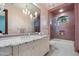 Luxurious bathroom with a marble countertop, chandelier lighting, and a tiled shower at 8515 E Sutton Dr, Scottsdale, AZ 85260