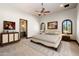 Bright bedroom with arched windows, a patterned rug, and neutral decor, offering a relaxing atmosphere at 8515 E Sutton Dr, Scottsdale, AZ 85260