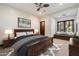 Comfortable bedroom with a large window seat, a ceiling fan, and neutral decor with a wooden bed frame at 8515 E Sutton Dr, Scottsdale, AZ 85260