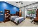 Stylish bedroom boasts a vibrant blue accent wall, built-in shelving, and window seating at 8515 E Sutton Dr, Scottsdale, AZ 85260