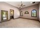 Bedroom featuring carpet, three windows and adjacent bathroom at 8515 E Sutton Dr, Scottsdale, AZ 85260