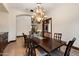 Cozy dining space with chandelier lighting and seating for eight, adjacent to a hallway at 8515 E Sutton Dr, Scottsdale, AZ 85260