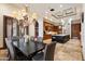 Spacious dining room with travertine tile, coffered ceilings and adjacent to kitchen and butler's pantry at 8515 E Sutton Dr, Scottsdale, AZ 85260