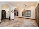 Open dining room featuring chandelier lighting, tiled floor, and arched doorways at 8515 E Sutton Dr, Scottsdale, AZ 85260