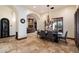 Formal dining area with a dark wood table and chairs, featuring a chandelier and stone floors at 8515 E Sutton Dr, Scottsdale, AZ 85260