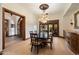 Dining room area showcasing a dark wood table and chairs, wooden trim, and wood flooring at 8515 E Sutton Dr, Scottsdale, AZ 85260