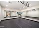 Mirrored exercise room featuring modern lighting, black rubberized flooring, and wall-mounted television at 8515 E Sutton Dr, Scottsdale, AZ 85260