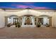 Inviting front entrance with brick pavers, arched doorways, and string lights creating a warm ambiance at 8515 E Sutton Dr, Scottsdale, AZ 85260
