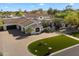 Beautiful home featuring a circular driveway, well-manicured lawn, and a three-car garage at 8515 E Sutton Dr, Scottsdale, AZ 85260