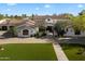 Beautiful home featuring a front walkway, manicured lawn, and mature landscaping at 8515 E Sutton Dr, Scottsdale, AZ 85260