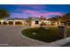 Charming front exterior with lush lawn, mature trees, and multi-car garage at 8515 E Sutton Dr, Scottsdale, AZ 85260