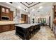 Spacious kitchen with an extended island offering seating, stainless steel appliances, and tile backsplash at 8515 E Sutton Dr, Scottsdale, AZ 85260
