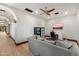 Spacious living room featuring a comfortable sofa, a TV, and an arched entryway at 8515 E Sutton Dr, Scottsdale, AZ 85260