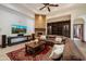 Inviting living room with stone fireplace, built-in bookcase, a ceiling fan and plush seating at 8515 E Sutton Dr, Scottsdale, AZ 85260