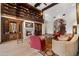 Elegant living room with a stone fireplace, custom bookshelf, and comfortable seating arrangements at 8515 E Sutton Dr, Scottsdale, AZ 85260