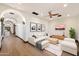 Bright living room featuring a modern sofa, wood floors, and an arched hallway at 8515 E Sutton Dr, Scottsdale, AZ 85260