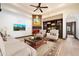 Inviting living room featuring hardwood floors, comfortable seating, and a stone fireplace with built-in bookshelves at 8515 E Sutton Dr, Scottsdale, AZ 85260