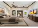 Tranquil main bedroom featuring neutral tones, a ceiling fan, and glass doors leading to the pool area at 8515 E Sutton Dr, Scottsdale, AZ 85260