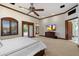 Expansive main bedroom featuring a ceiling fan, neutral carpet, and patio access to the pool at 8515 E Sutton Dr, Scottsdale, AZ 85260