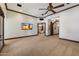 Expansive main bedroom features a ceiling fan, wood trim, and seamless access to an ensuite bath at 8515 E Sutton Dr, Scottsdale, AZ 85260
