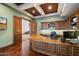 Home office featuring custom millwork, hardwood floors, and a beautiful coffered ceiling at 8515 E Sutton Dr, Scottsdale, AZ 85260