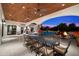 Expansive outdoor patio features ample seating, pool views, and a cozy fireplace, perfect for entertaining at 8515 E Sutton Dr, Scottsdale, AZ 85260