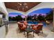 Outdoor entertaining area features a covered patio, stainless grill, comfortable seating and a pool with water features at 8515 E Sutton Dr, Scottsdale, AZ 85260
