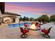 Backyard pool featuring a fire pit, fountain features, and outdoor seating for relaxation at 8515 E Sutton Dr, Scottsdale, AZ 85260