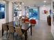 Open-concept living room with dining area and modern lighting fixtures at 8950 W Albeniz Pl, Tolleson, AZ 85353