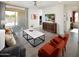 Cozy living room with modern furnishings, a stylish coffee table, and large windows at 8950 W Albeniz Pl, Tolleson, AZ 85353