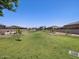 Expansive green common area with a playground, trees and manicured landscape in a beautiful planned community at 8954 W Albeniz Pl, Tolleson, AZ 85353