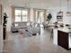 Inviting living room featuring a sectional sofa, dining area, and kitchen island, creating a comfortable and open living space at 8954 W Albeniz Pl, Tolleson, AZ 85353