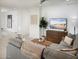 Cozy living room with a large sectional, modern TV, and decorative accents creating a relaxing and stylish atmosphere at 8954 W Albeniz Pl, Tolleson, AZ 85353