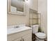 Bathroom features a vanity with a sink, a toilet, and shelving at 9021 W Elm St # 7, Phoenix, AZ 85037
