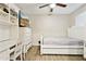 Bright bedroom with wood floors, ceiling fan, built-in desk, and a white day bed at 9021 W Elm St # 7, Phoenix, AZ 85037
