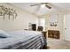 Bright bedroom with a decorative ceiling fan and a glimpse of a full bathroom at 9021 W Elm St # 7, Phoenix, AZ 85037
