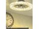 Close-up of a modern light fixture, and a clock can be seen in the background at 9021 W Elm St # 7, Phoenix, AZ 85037