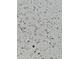 Close-up shot of the kitchen's white quartz countertop, featuring dark flecks and patterns at 9021 W Elm St # 7, Phoenix, AZ 85037