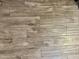 Light-colored wood-look tile flooring throughout main living areas of the home at 9021 W Elm St # 7, Phoenix, AZ 85037