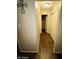 Hallway featuring wood flooring and closet at 9021 W Elm St # 7, Phoenix, AZ 85037