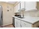 Well-lit kitchen boasting sleek countertops, stainless steel appliances, and stylish white cabinetry at 9021 W Elm St # 7, Phoenix, AZ 85037