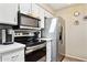 Modern kitchen equipped with stainless steel appliances and white cabinetry for a clean, streamlined look at 9021 W Elm St # 7, Phoenix, AZ 85037