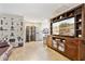 Cozy living room featuring wood floors, built in shelving, and a large entertainment center at 9021 W Elm St # 7, Phoenix, AZ 85037