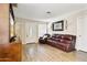 Comfortable living room with wood floors, a decorative fireplace, and plenty of natural light at 9021 W Elm St # 7, Phoenix, AZ 85037