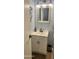Powder room features a modern vanity, lighting, framed mirror, and neutral wall color at 9021 W Elm St # 7, Phoenix, AZ 85037